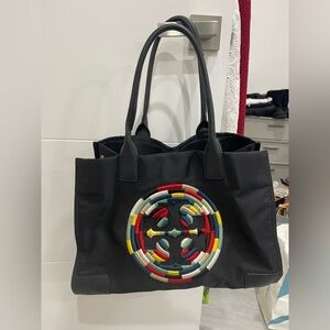 Tory Burch collection use but in good condition rip in one side of the handle